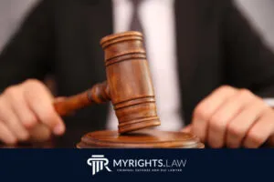 A judge's wooden gavel rests on a block, with a blurred figure in a suit behind it and the MyRights.Law logo and Los Angeles Misdemeanor Lawyer text at the bottom of the image.