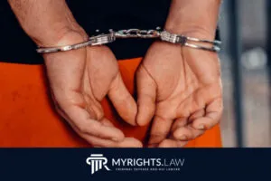 Person with hands cuffed behind their back, wearing an orange outfit—highlighting the seriousness of felony charges or domestic violence in California; MYRIGHTS.LAW criminal defense and DUI lawyer logo appears at the bottom.