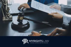 People working at a desk with legal documents, a gavel, and a statue of Lady Justice, highlighting Pasadena criminal defense attorneys. The My Rights Law logo appears at the bottom.