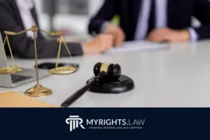 A gavel and scales of justice sit on a desk in front of two people in business attire, highlighting the expertise of a Rancho Cucamonga CACI Removal Lawyer. The MyRights.Law logo and tagline are displayed at the bottom of the image.