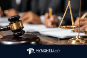 A judge’s gavel, scales of justice, and people writing at a desk, with the MyRights.Law logo at the bottom, illustrate the role of a Rancho Cucamonga CACI Removal Lawyer in seeking justice and advocating for clients’ rights.