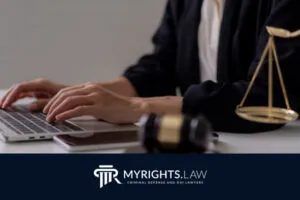 Person typing on a laptop next to a gavel and scales of justice, with the MyRights.Law logo and tagline at the bottom—highlighting the expertise of a Rancho Cucamonga CACI Removal Lawyer.