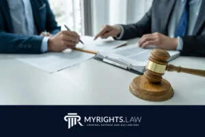 Two people in suits review legal documents at a desk with a gavel and clipboard, highlighting the expertise of a Rancho Cucamonga CACI Removal Lawyer. The MYRIGHTS.LAW logo and tagline appear at the bottom.