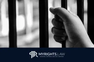 A hand grips jail bars, suggesting incarceration; the image features the MyRights.Law logo and the text 
