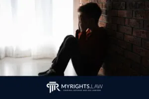 A child sits on the floor against a brick wall, covering their face with their hands as light streams through a window. MyRights.Law logo and Rancho Cucamonga CACI Removal Lawyer text are at the bottom of the image.
