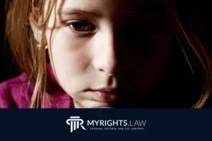 A young girl with a serious expression, half of her face in shadow, with the My Rights Law logo and text at the bottom, highlighting the support of a Rancho Cucamonga CACI Removal Lawyer.