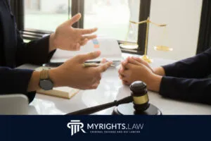Two people sit at a desk discussing legal documents and mistakes to avoid; a gavel, scales of justice, and book are visible. The image includes the MyRights.Law logo and tagline.